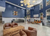 Thumbnail 23 of 46 - a lobby with couches and chairs and a table