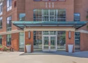 Thumbnail 44 of 46 - the entrance to a brick building with glass doors
