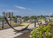 Thumbnail 40 of 46 - a row of hammocks on a rooftop overlooking the city
