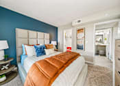 Thumbnail 12 of 34 - A bedroom with a large bed and a blue wall.