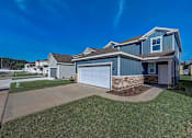 Thumbnail 17 of 21 - a home with a blue siding and a blue garage door