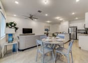 Thumbnail 30 of 30 - Boatman Hammock Townhomes in Lake Worth, FL photo of  a dining area with a table and chairs and a living room with a kitchen