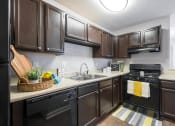 Thumbnail 1 of 15 - Averly apartments in Jonesboro Georgia photo of kitchen with espresso cabinets