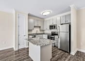 Thumbnail 1 of 48 - Modern Hawks Landing kitchen in Hickory NC with stainless-steel appliances and a large island