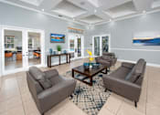Thumbnail 20 of 28 - A living room with a brown leather couch and a coffee table.