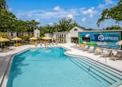 Thumbnail 4 of 34 - A large swimming pool with a Genesis sign in the background.