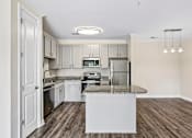 Thumbnail 10 of 48 - Upgraded Hawks Landing kitchen featuring stainless-steel appliances, quartz counters, and a central island
