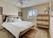 Thumbnail 7 of 15 - Derby Park Apartments in Daytona Beach, FL photo of a bedroom with a bed and a ceiling fan