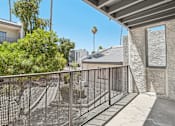 Thumbnail 10 of 34 - A balcony with a metal railing and a concrete wall.