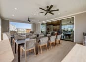 Thumbnail 46 of 56 - a large dining area with a large table and chairs and a ceiling fan