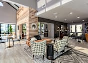 Thumbnail 17 of 34 - A modern living room with a wooden pillar and a skylight.