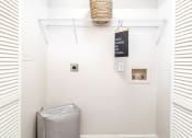 Thumbnail 16 of 20 - a white bathroom with a trash can and a rack on the wall
