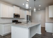 Thumbnail 3 of 25 - Dog-Friendly Homes For Rent In Fountain Inn, SC - Pine Ridge Place - Kitchen, White Cabinets, Stone Countertop, Stainless Steel Appliances