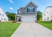 Thumbnail 1 of 25 - a house with a white garage door and a driveway