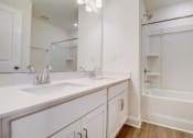 Thumbnail 5 of 20 - a bathroom with two sinks and a bathtub