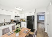 Thumbnail 1 of 20 - Updated kitchen in Marietta GA apartment with black appliances and granite-style counters