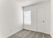 Thumbnail 19 of 23 - an empty room with a door and a window