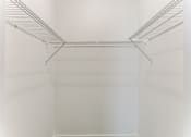 Thumbnail 20 of 23 - a walk in closet with white walls and a clear wire shelving system