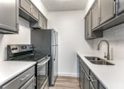Thumbnail 14 of 23 - a kitchen with gray cabinets and white countertops