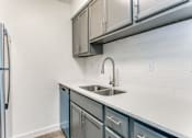Thumbnail 15 of 23 - a kitchen with a sink and a refrigerator