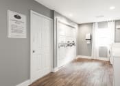 Thumbnail 22 of 25 - Apartments In Sandy Springs, GA for Rent – Celebration at Sandy Springs - a laundry room with white doors and gray walls