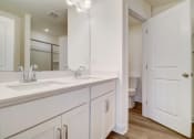 Thumbnail 16 of 20 - a bathroom with two sinks and a toilet