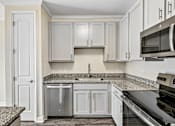 Thumbnail 11 of 48 - A modern Hawks Landing kitchen in Hickory NC featuring granite countertops and stainless-steel appliances