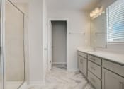 Thumbnail 13 of 19 - a bathroom with a large mirror and a walk in shower