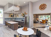 Thumbnail 15 of 34 - A modern kitchen with a large island and a dining table set for two.