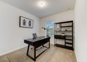Thumbnail 20 of 30 - Boatman Hammock Townhomes in Lake Worth, FL photo of  a home office with a desk and a bookshelf