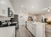 Thumbnail 17 of 29 - Pet-Friendly Rentals in Lady Lake, FL – The Groves at Lake Ella - luxury kitchen with white cabinets and hardwood floors