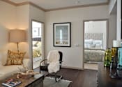 Thumbnail 18 of 33 - Living room with doors to bedrooms and wood floor