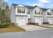 Thumbnail 1 of 26 - Harris Trail Luxury Townhomes for rent Richmond Hill, GA photo of white townhome with garage