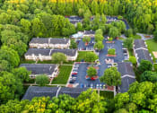 Thumbnail 20 of 20 - an aerial view of a parking lot with houses and trees