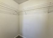Thumbnail 11 of 24 - A white wall with a metal rack on it.