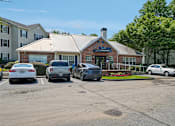 Thumbnail 32 of 34 - A parking lot with cars and a building with a sign that says "Theatre".