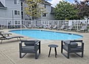 Thumbnail 12 of 17 - a swimming pool with chairs and tables around it