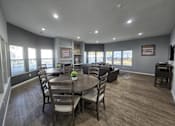 Thumbnail 6 of 17 - a dining room with a table and chairs and a living room with couches