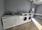 Thumbnail 14 of 17 - a laundry room with two washes and two dryers in it