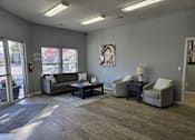 Thumbnail 7 of 17 - a living room with couches and chairs and a coffee table