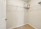 Thumbnail 22 of 47 - A white door is open to a room with a shelf and a pillow on it.