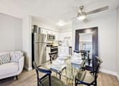 Thumbnail 7 of 46 - A modern kitchen with a glass dining table and chairs.
