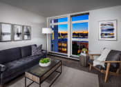 Thumbnail 2 of 50 - Apartments for Rent in Greenwood - The Morrow Living Room with Stylish Decor, White Walls, Vinyl Plank Flooring, and Large Windows