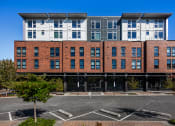 Thumbnail 43 of 50 - Greenwood Apartments - Exterior View of The Morrow Apartments Building with Parking Access