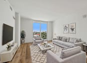Thumbnail 1 of 31 - Modern open-concept living room in a pet-friendly one-bedroom apartment at Riverview One Apartments in Downtown Miami near Brickell, the Miami River, Miami Worldcenter, and the Health District.
