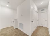 Thumbnail 26 of 30 - Boatman Hammock Townhomes in Lake Worth, FL photo of  a room with white walls and white doors and a carpeted floor