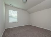 Thumbnail 15 of 25 - a bedroom with a carpeted floor and a window with a blind