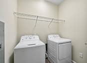Thumbnail 18 of 48 - A bright Hawks Landing laundry room in Hickory NC featuring a washer and dryer