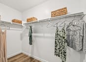 Thumbnail 22 of 45 - Clothes hanging on a rack in a room.