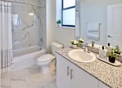 Thumbnail 8 of 36 - Modern bathroom at Gateway Luxury Apartments with a luxury tub and shower combo featuring sleek fixtures and elegant tilework.